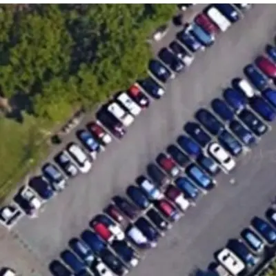 A parking lot beside trees